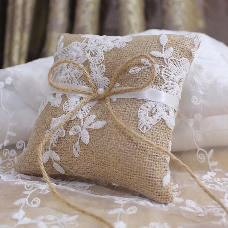 Decorative pillow with lace and burlap material on a soft background