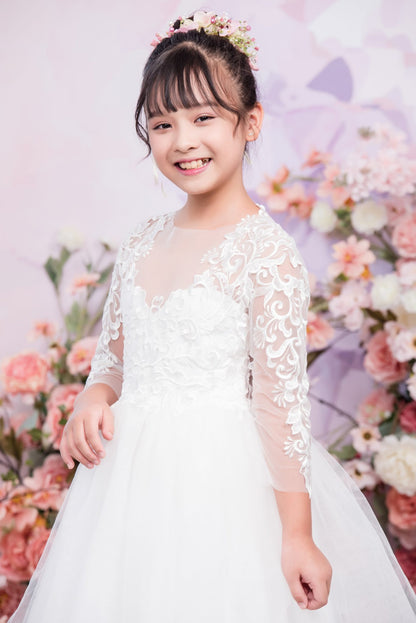 Young girl in a white dress with floral decorations against a floral background