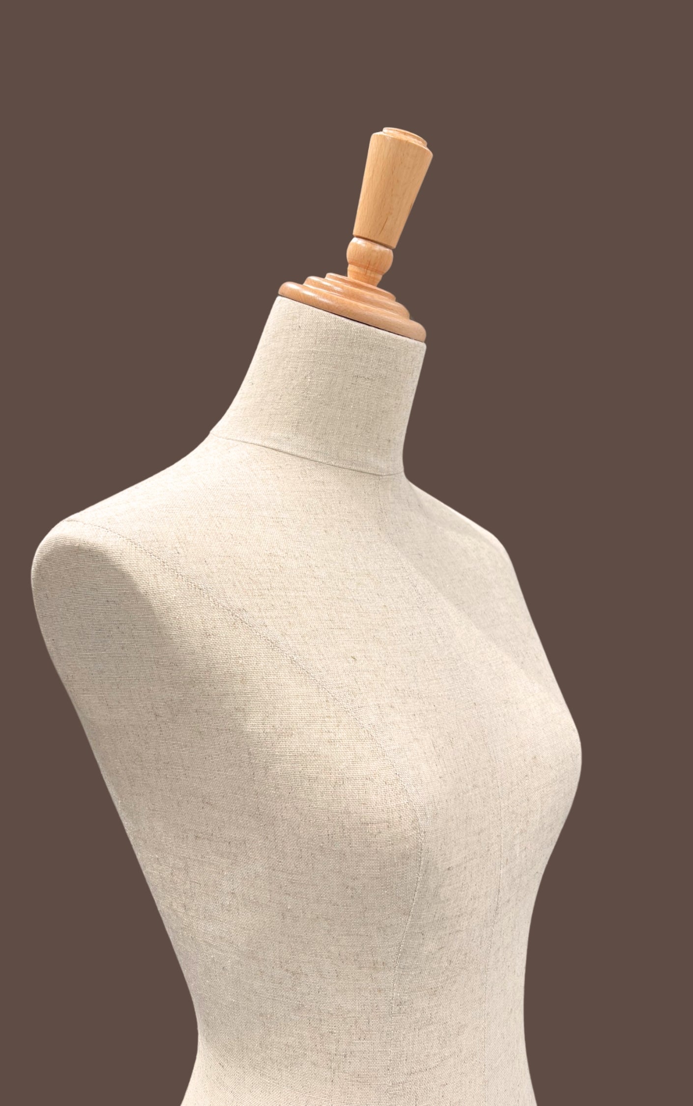Mannequin torso with wooden headrest on a brown background
