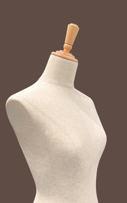 Mannequin torso with wooden headrest on a brown background