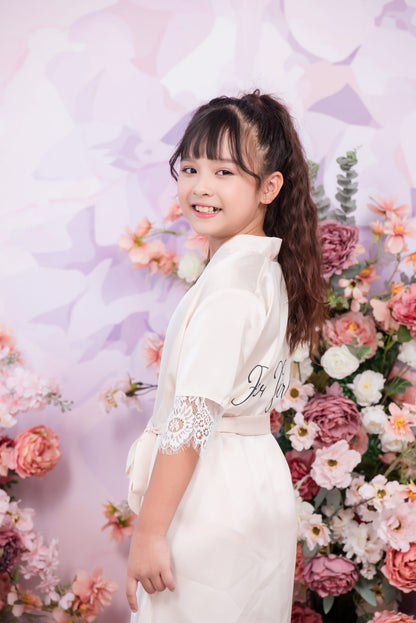 Young girl in a white dress with floral decorations and a purple background
