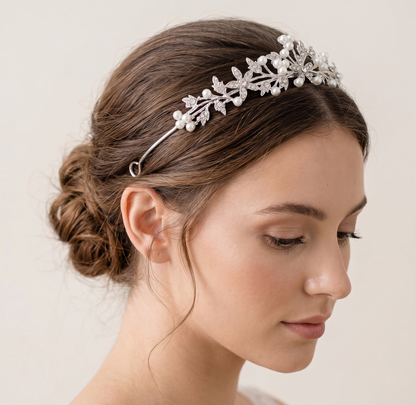 Woman wearing a decorative headband with pearls on a plain background