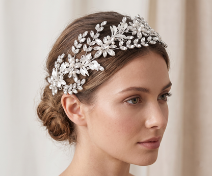 Woman wearing a decorative silver headpiece against a neutral background