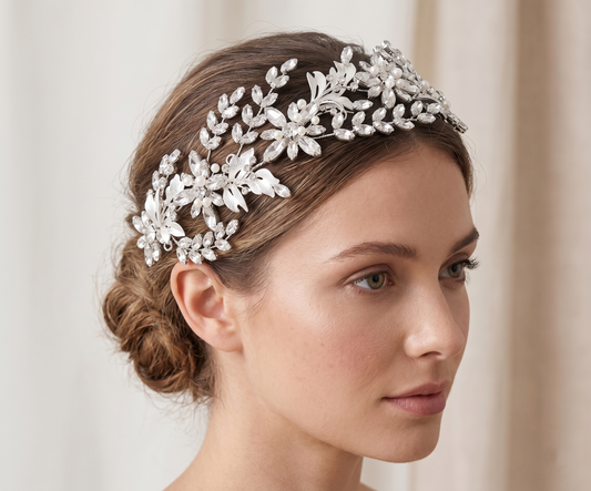 Woman wearing a decorative silver headpiece against a neutral background