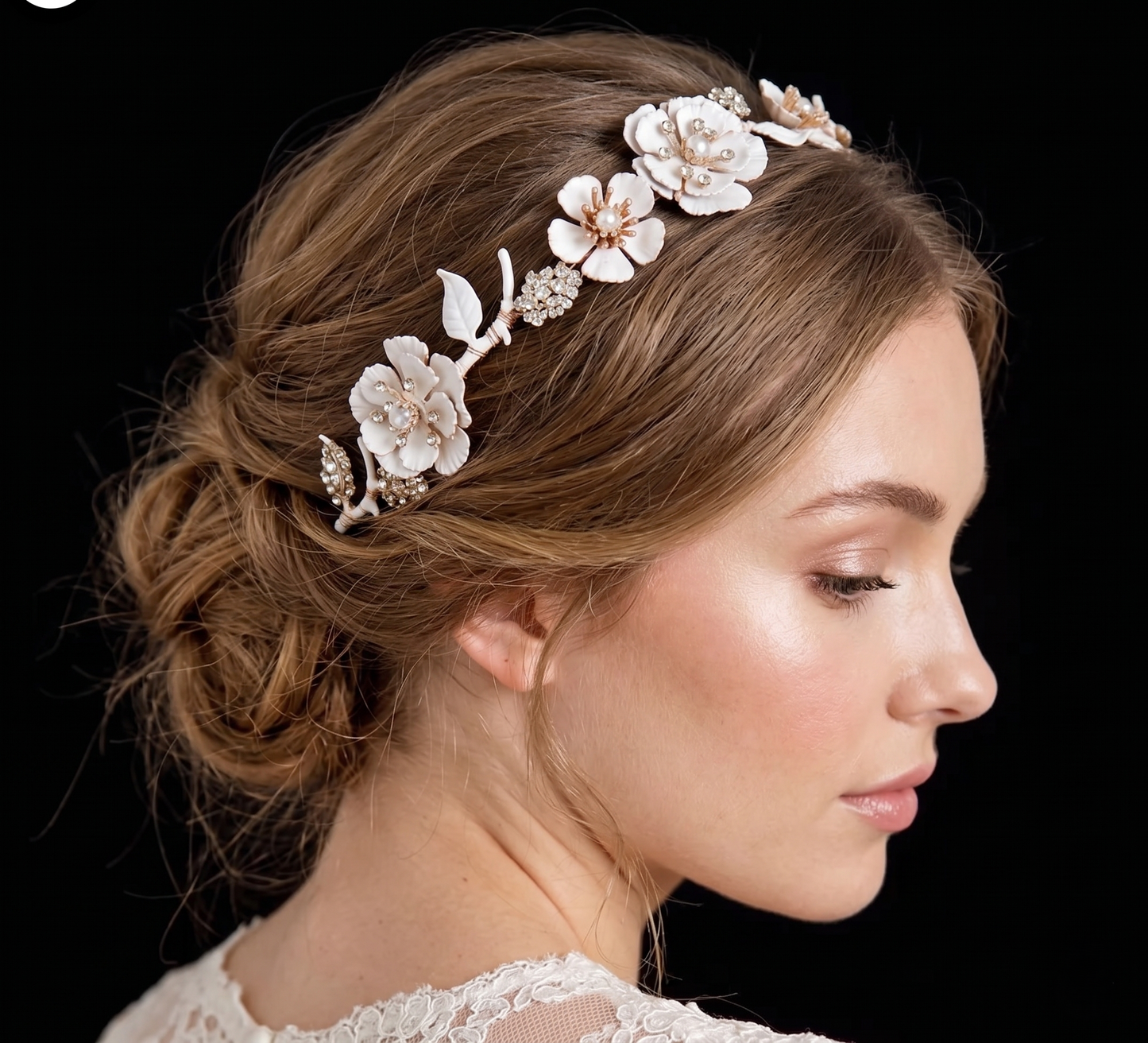 Woman wearing a floral hair accessory with a black background