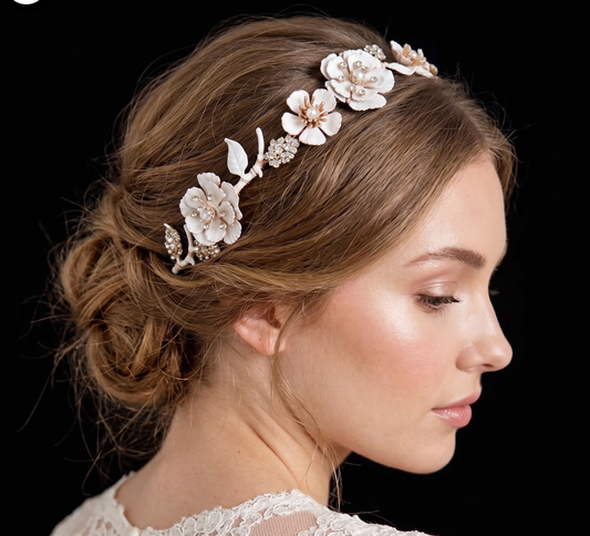Woman wearing a floral hair accessory with a black background