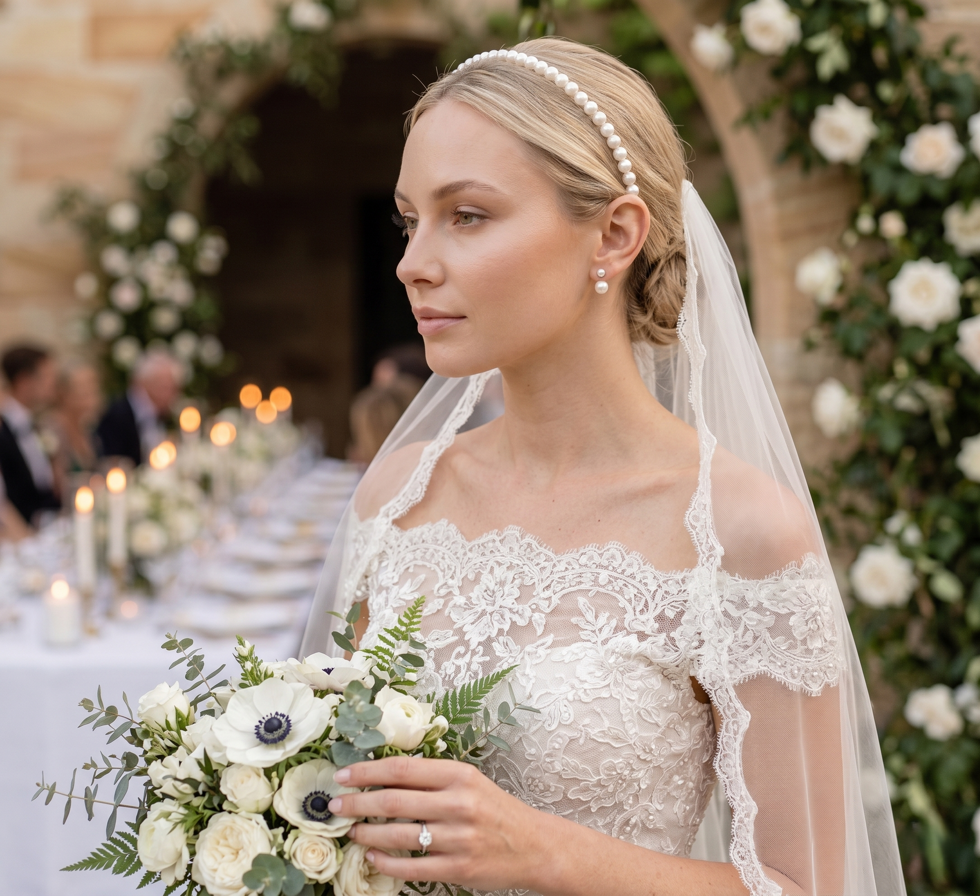 Bride holding a bouquet in an elegant outdoor setting with floral decorations.