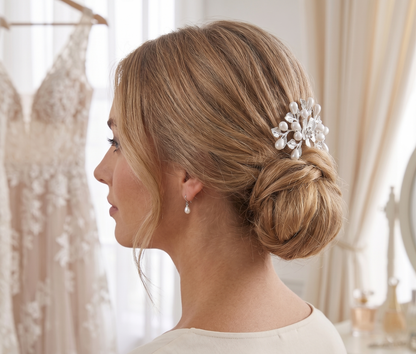 Woman with styled hair featuring a decorative hairpiece in a bridal setting.