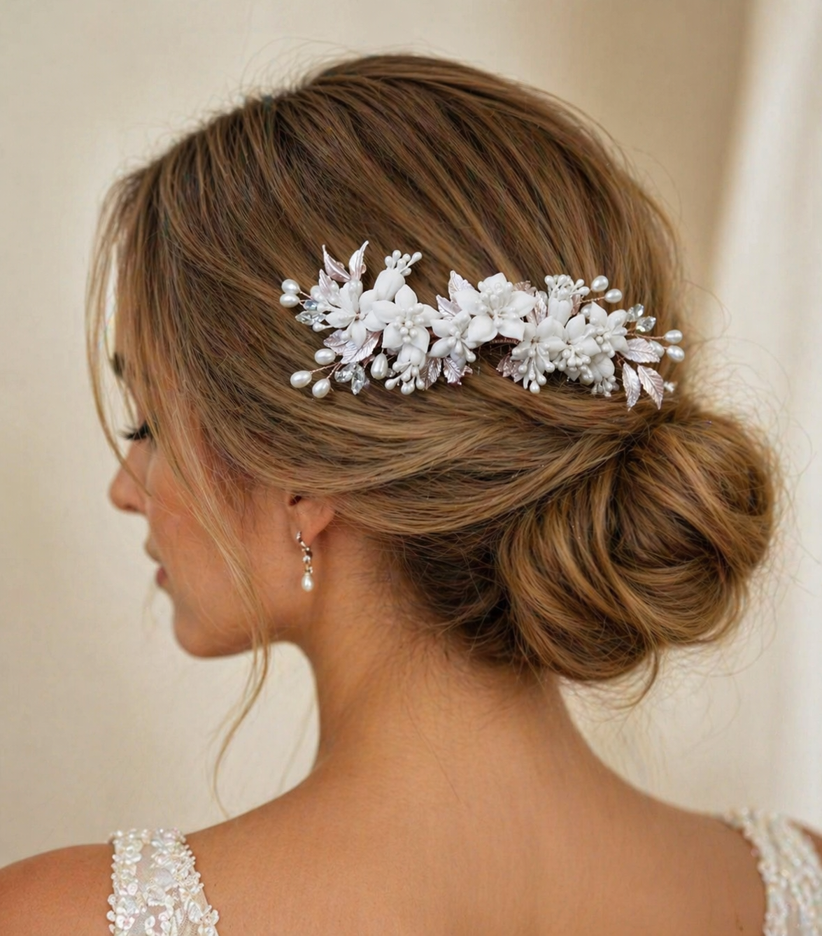 Woman with elegant hair styled with a decorative hairpiece against a neutral background