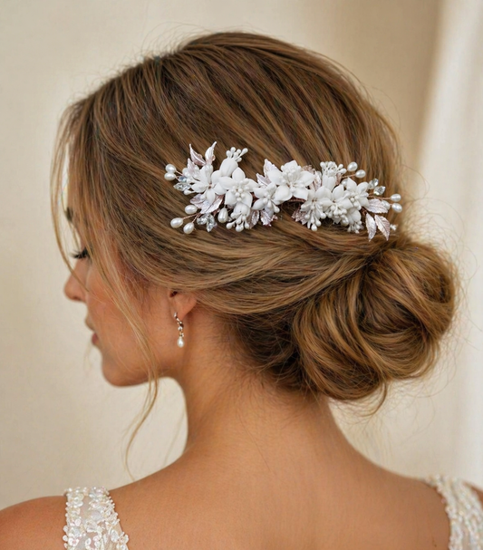 Woman with elegant hair styled with a decorative hairpiece against a neutral background