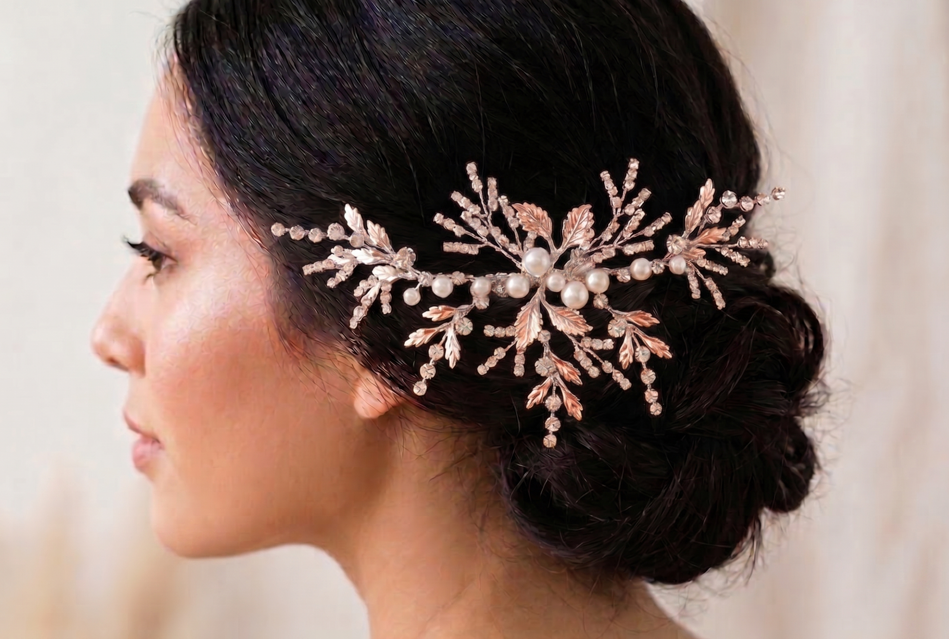 Woman wearing a decorative hairpiece with pearls and crystals.