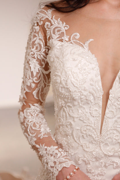 Close-up of a lace wedding dress with long sleeves and a low back.