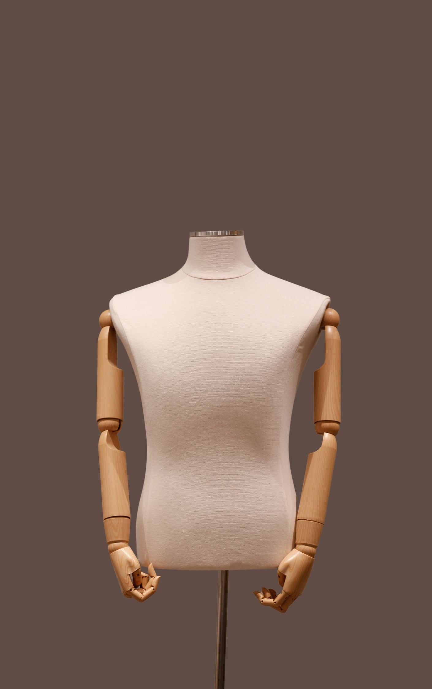 Mannequin torso with wooden arms and legs on a dark background