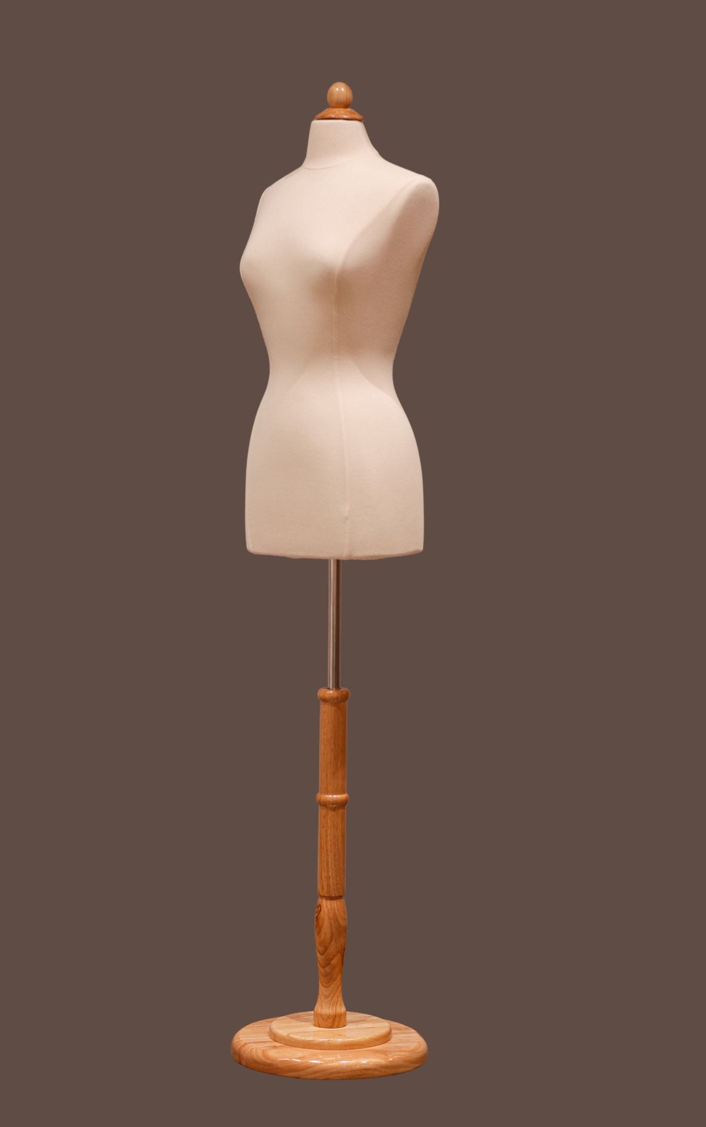 Mannequin torso on a wooden stand against a dark background
