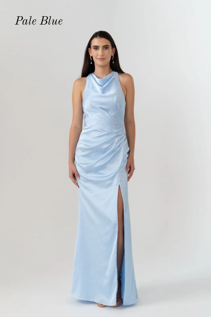 A woman modeling a sleeveless pale blue halter-neck maxi dress with a draped cowl neckline, ruched bodice, and a high front slit, shown against a light gray studio background with the text 'Pale Blue' in the top left.