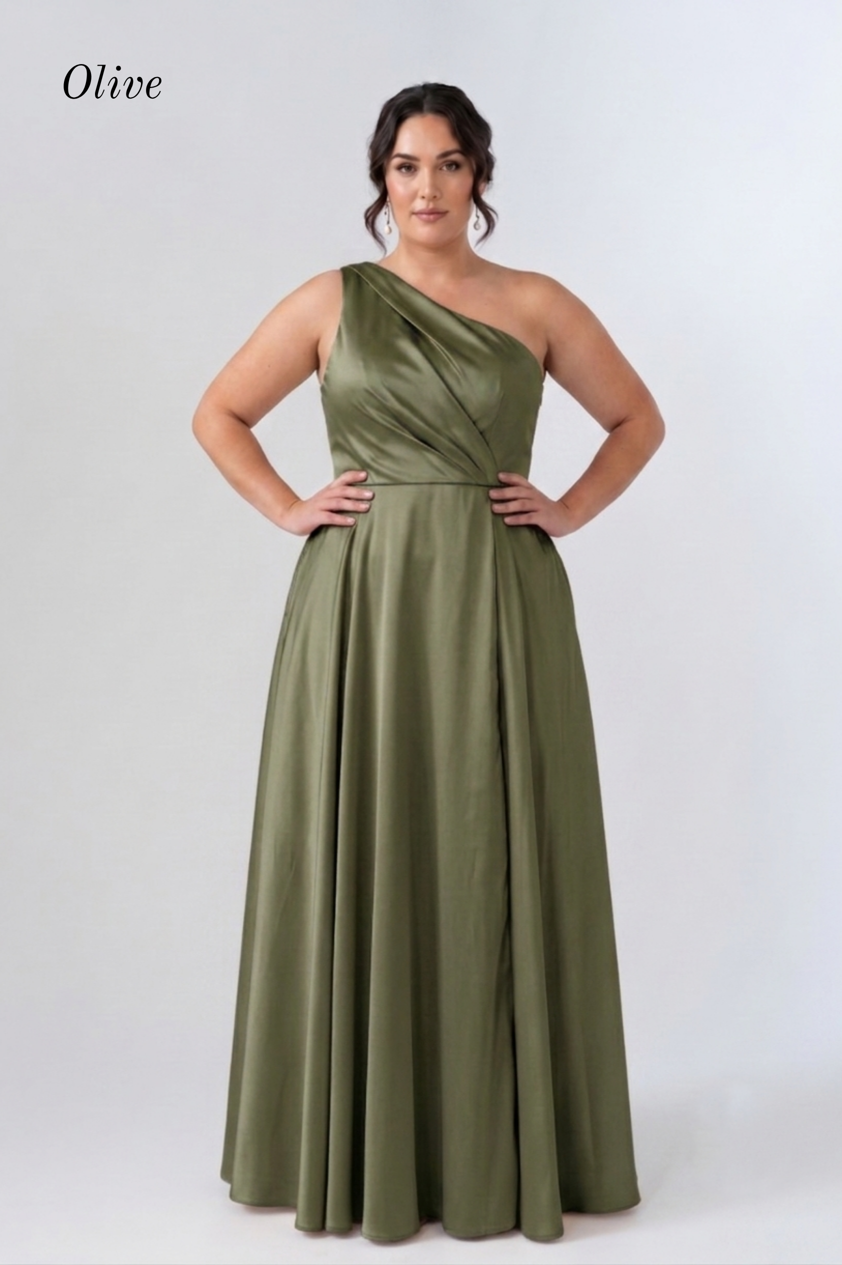A woman modeling an olive green one-shoulder floor-length gown against a light gray studio background. The word 'Olive' appears in the upper left corner.