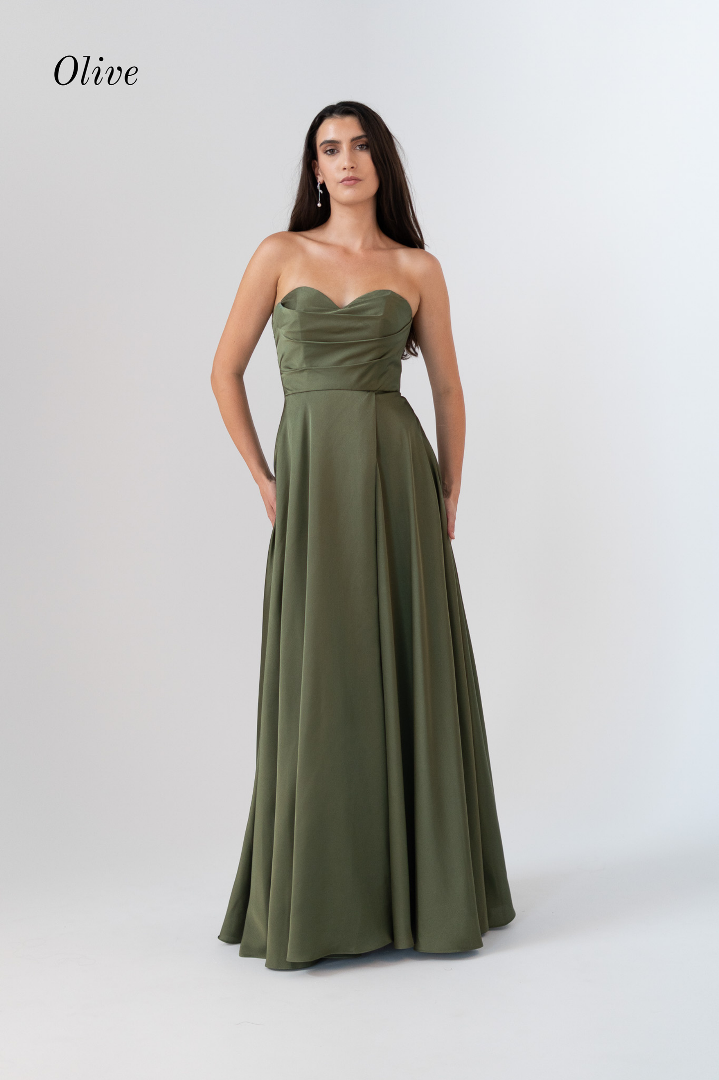 A woman modeling an olive green strapless floor-length gown against a light gray studio background. The word 'Olive' appears in the upper left corner.