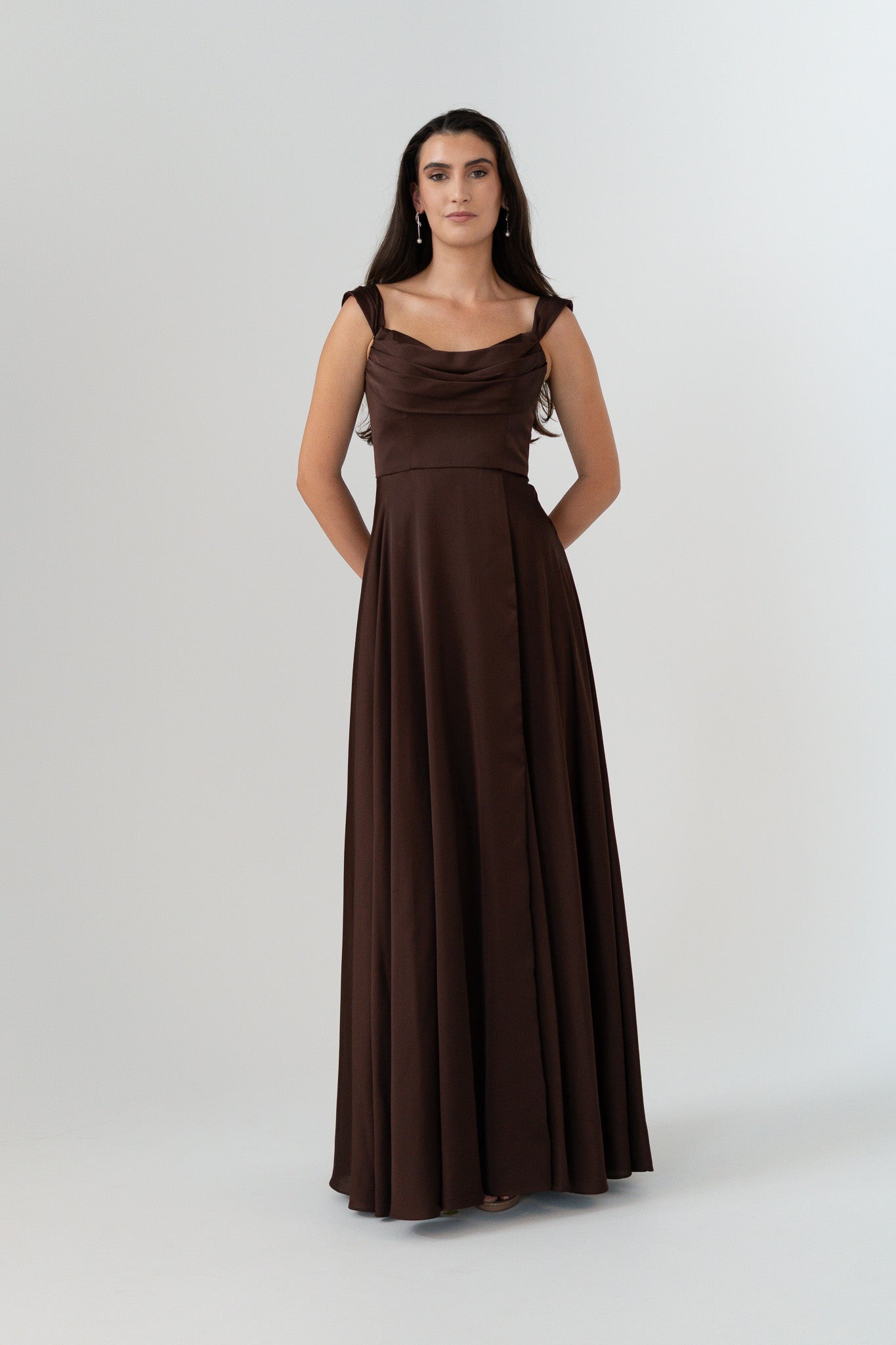 Woman wearing a brown evening gown on a white background