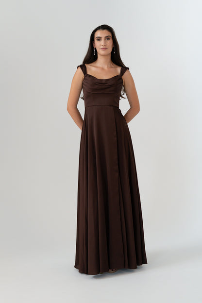 Woman wearing a brown evening gown on a white background