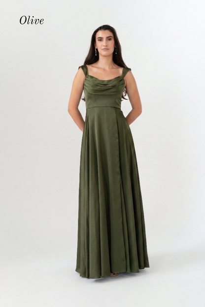 A woman modeling an olive green sleeveless maxi dress with a draped neckline and a fitted waist, standing against a plain light gray studio background. The word 'Olive' appears in the upper left corner.