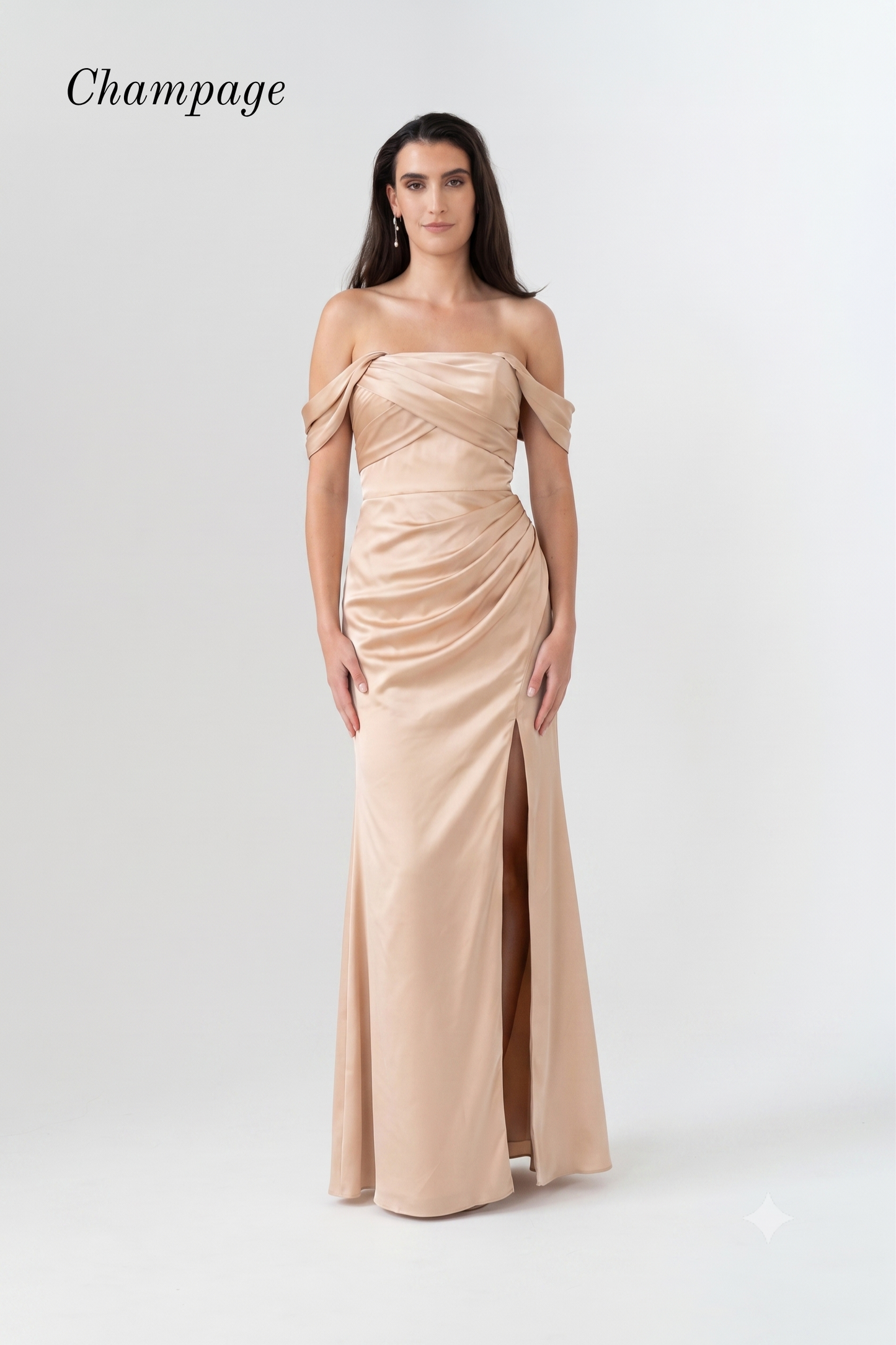 A woman modeling a champagne strapless off-the-shoulder floor-length gown with a draped bodice and front slit, photographed against a light gray studio background. The word 'Champagne' appears in the upper left.