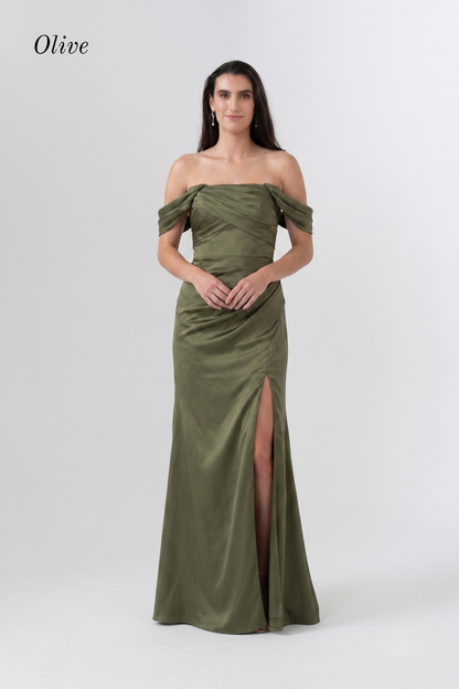 A woman modeling an olive green off-the-shoulder floor-length gown with a high front slit, photographed against a light gray studio background. The word 'Olive' appears in the upper left corner.