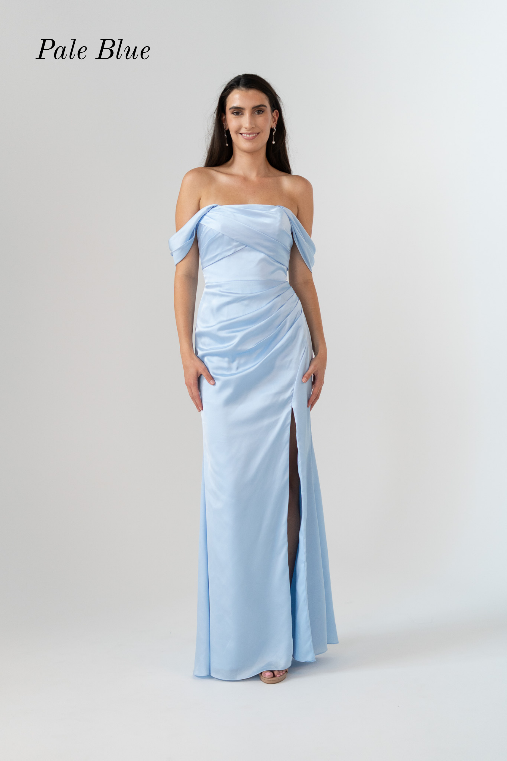 A woman modeling a pale blue off-the-shoulder floor-length gown with a draped bodice and a high front slit, shown against a light gray studio background with the text 'Pale Blue' in the upper left.