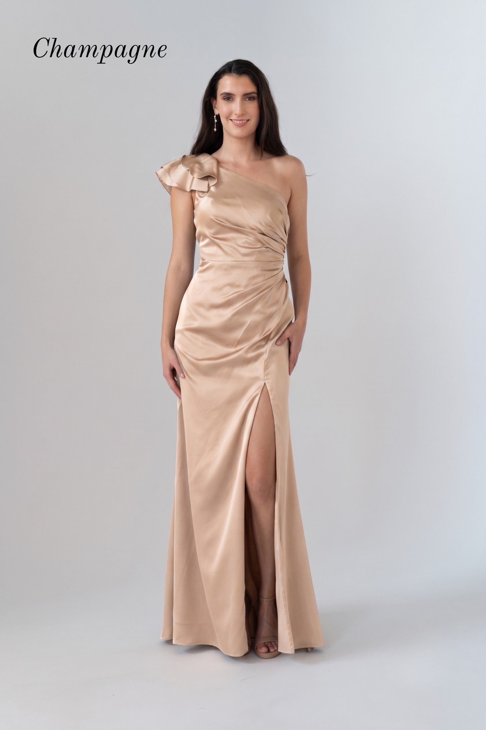 A woman modeling a champagne satin one-shoulder evening gown with a high thigh slit, shown against a light gray studio background with the word 'Champagne' in the top left.
