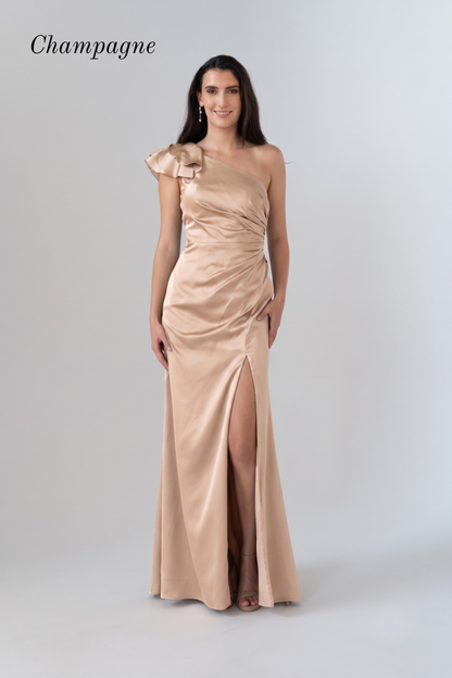 A woman modeling a champagne satin one-shoulder evening gown with a high thigh slit, shown against a light gray studio background with the word 'Champagne' in the top left.