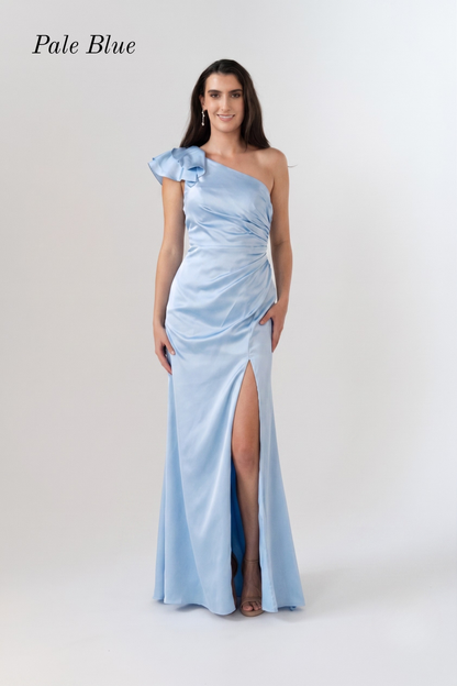 A woman modeling a pale blue one-shoulder floor-length gown with a ruched bodice, ruffled shoulder detail, and a high front slit, shown against a light gray studio background with the text 'Pale Blue' in the upper left.