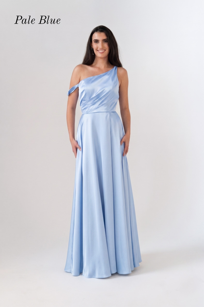 A woman modeling a pale blue one-shoulder floor-length gown against a light gray studio background. The text 'Pale Blue' appears in the upper left corner.