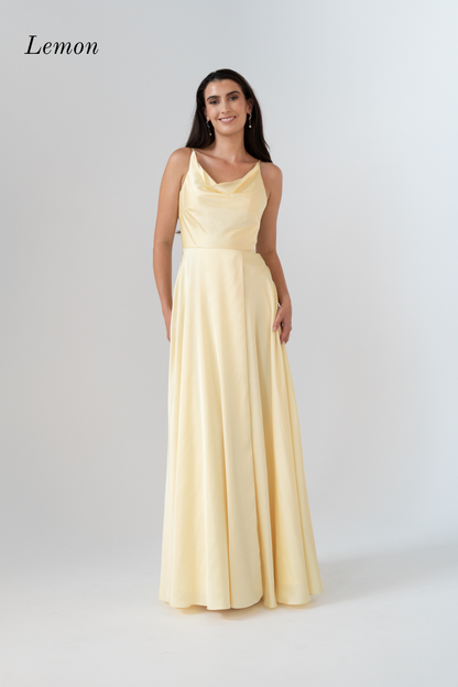 A woman modeling a sleeveless, floor-length yellow dress with a draped neckline and a fitted waist, shown against a light gray studio background. The word 'Lemon' appears in the upper left corner.