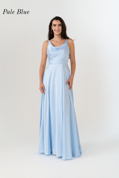 A woman modeling a sleeveless pale blue floor-length gown with a draped neckline and flowing skirt, photographed against a light gray studio background. The text 'Pale Blue' appears in the upper left corner.
