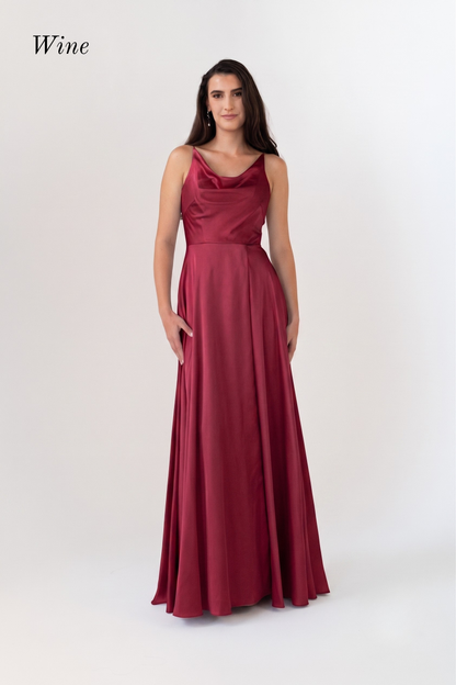 A woman modeling a sleeveless, floor-length wine red dress with a draped neckline and a fitted waist, shown against a plain light background with the word 'Wine' in the top left.