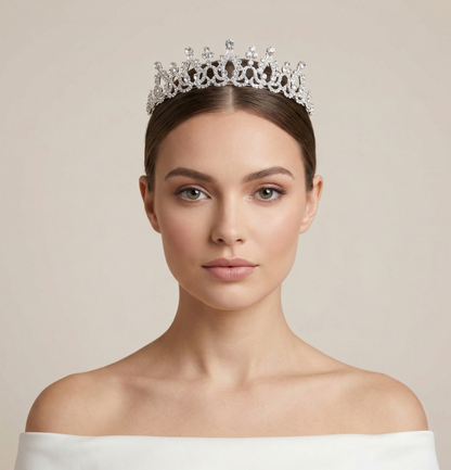 Woman wearing a sparkling tiara against a plain background