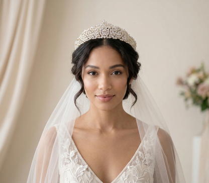 Woman wearing a tiara and veil with a soft background