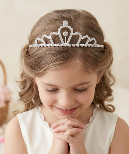 Young girl wearing a silver tiara with a soft background
