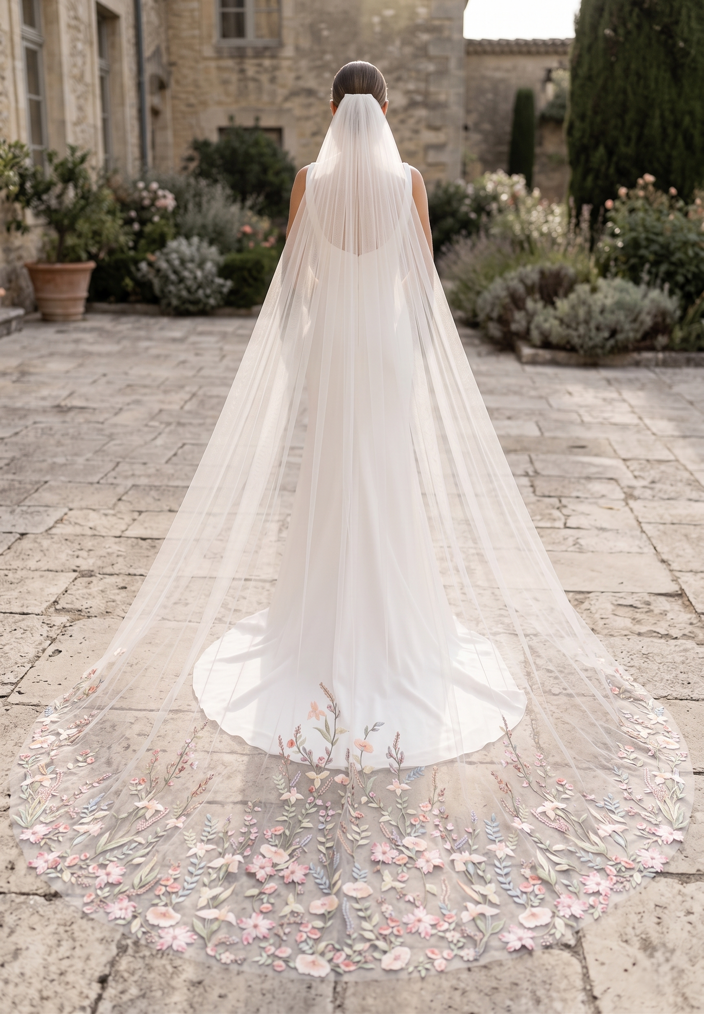 Bride with a long, elegant veil in an outdoor setting
