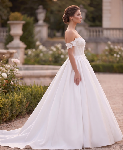 Woman in a white wedding dress standing in a garden setting