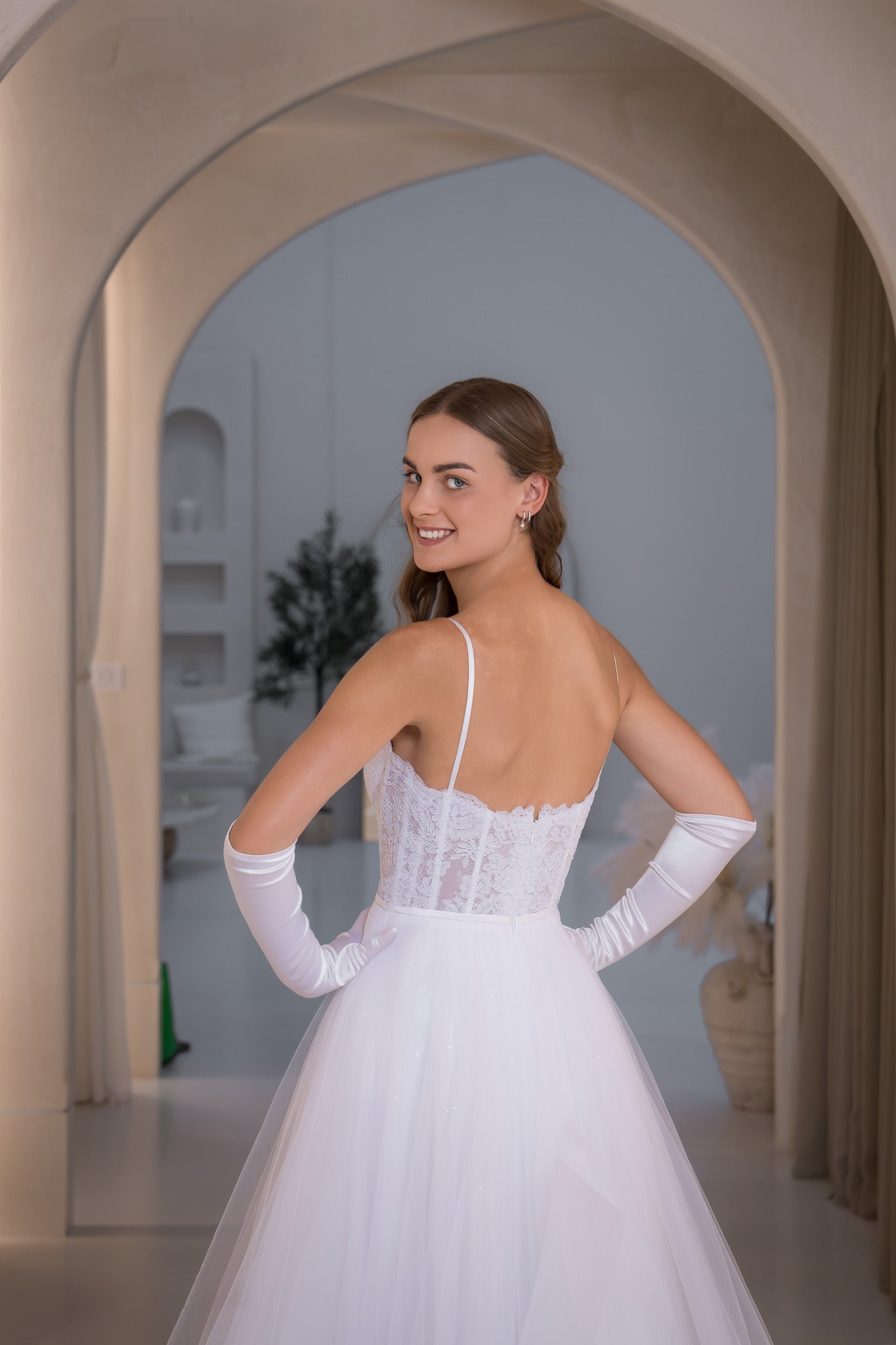 Woman in a white wedding dress standing in an archway