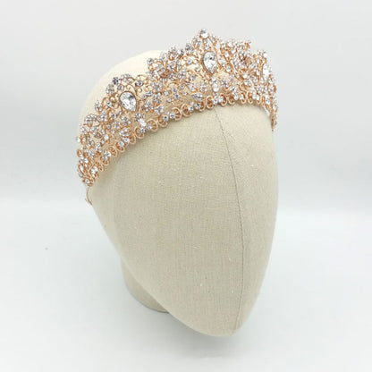 Rose gold headband with crystals on a mannequin head against a white background