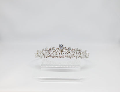 Diamante tiara on a white stand against a light gray background