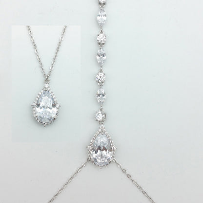 Silver necklace with teardrop-shaped pendants on a light gray background