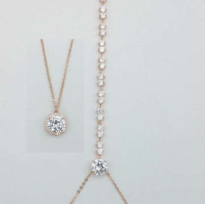 Two rose gold necklaces with diamond pendants on a light gray background