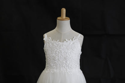 White lace dress on a mannequin against a black background