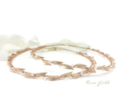Rose gold bracelet on a white fabric background