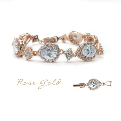 Rose gold bracelet with clear gemstones on a white background