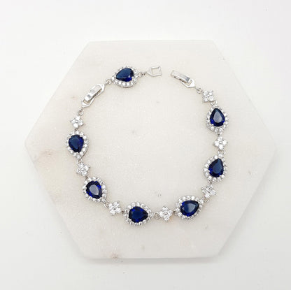 Silver bracelet with blue gemstones on a white background