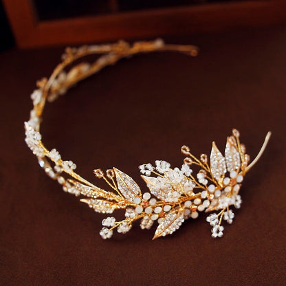 Gold and pearl leaf headband on a brown background