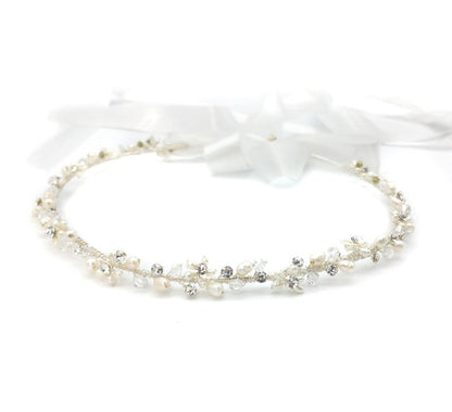 Delicate pearl and crystal headband on a white background